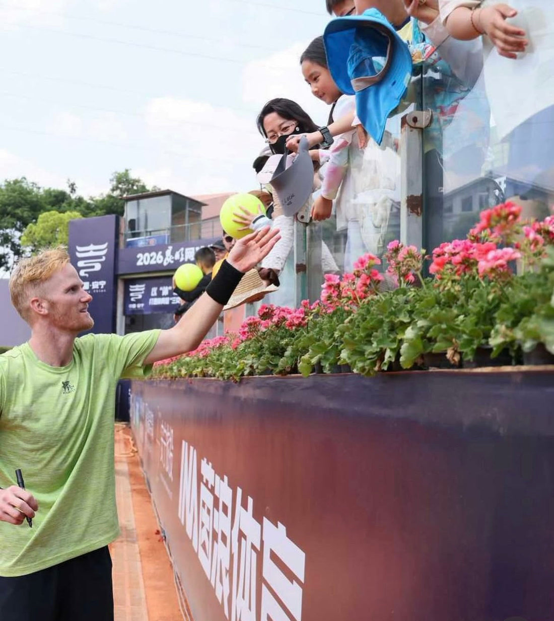 Professional Tennis Player Court Lock signs autographs at a tournament